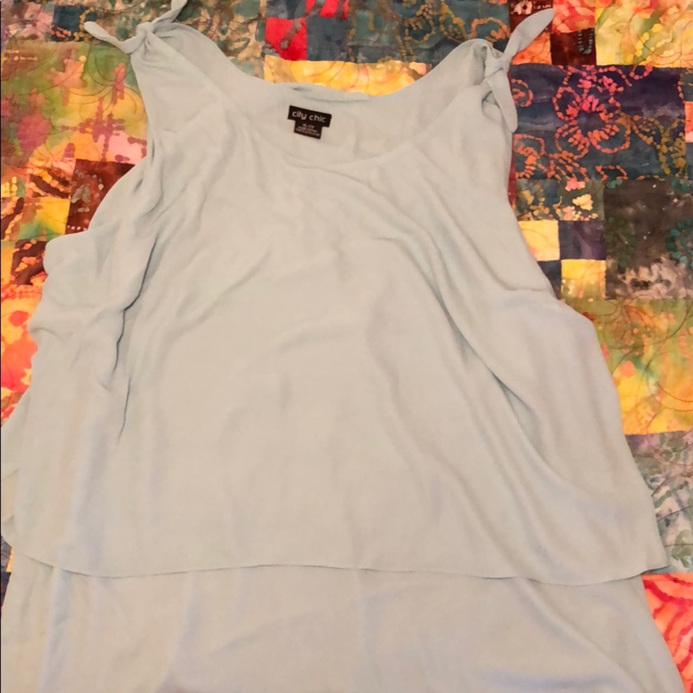 Light blue bow knot sleeveless blouse.